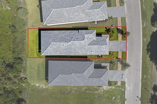 an aerial view of a house with a yard