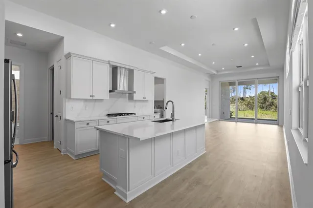 a kitchen with a sink stove and refrigerator