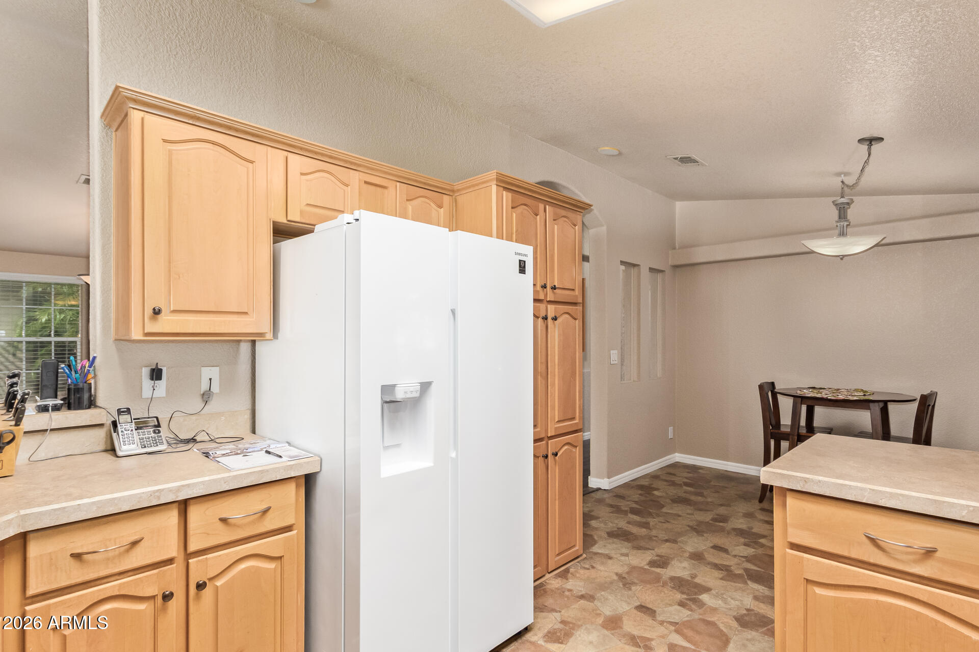 3301 South Goldfield Road, Unit 4028 Apache Junction, AZ 85119 - Photo 20 of 43 a kitchen with a refrigerator a sink and cabinets