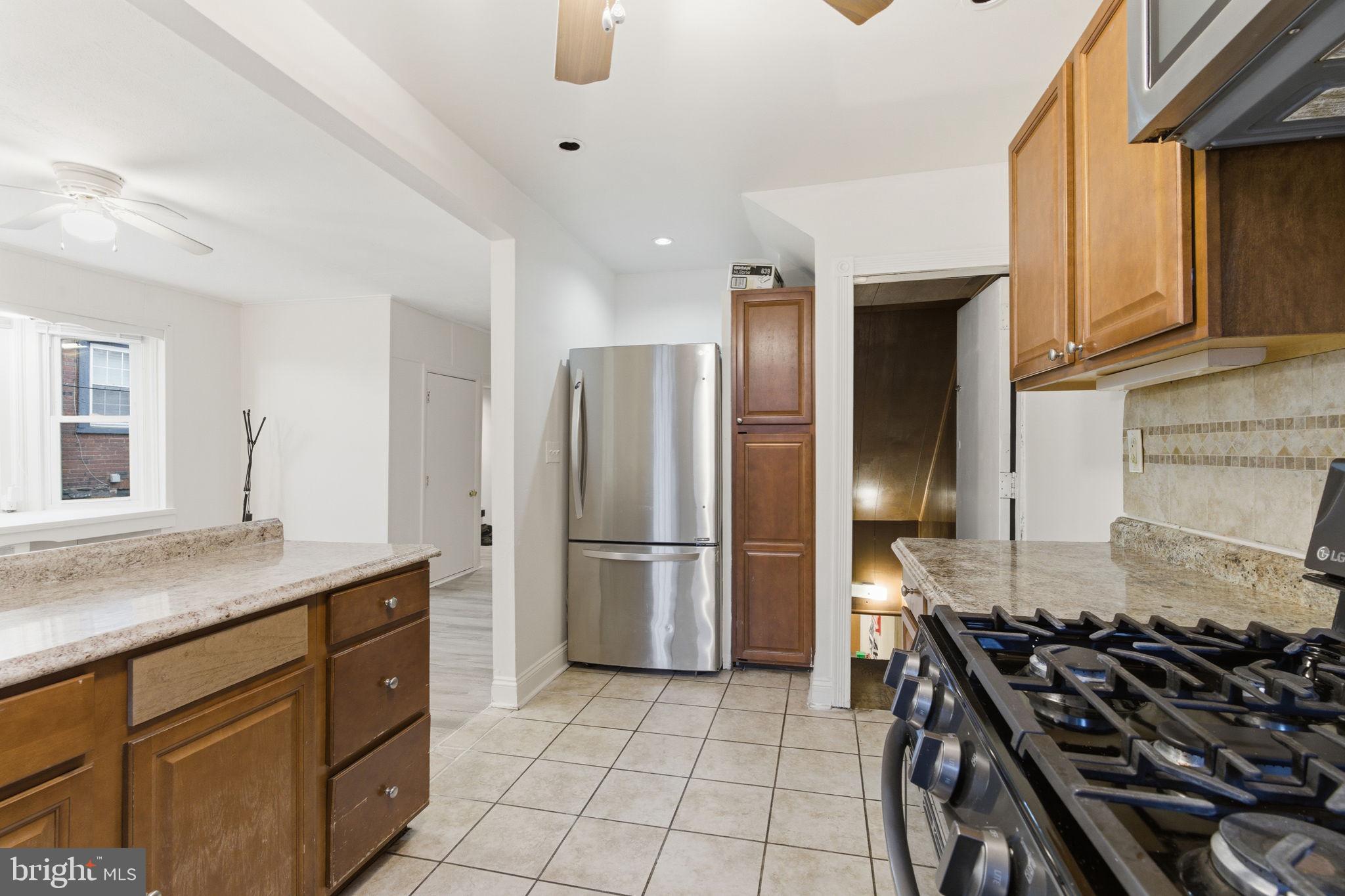 212 Upland Road Merion Station, PA 19066 - Photo 12 of 32 a kitchen with a stove and a refrigerator