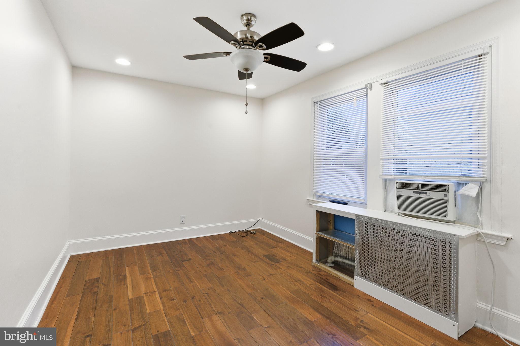 212 Upland Road Merion Station, PA 19066 - Photo 14 of 32 wooden floor in an empty room with a fireplace