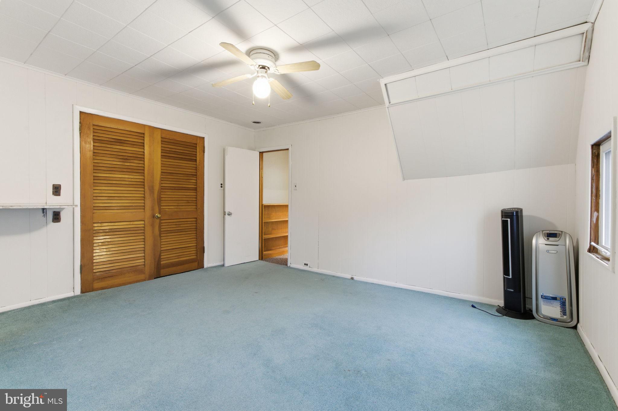 212 Upland Road Merion Station, PA 19066 - Photo 18 of 32 an empty room with closet and a ceiling fan