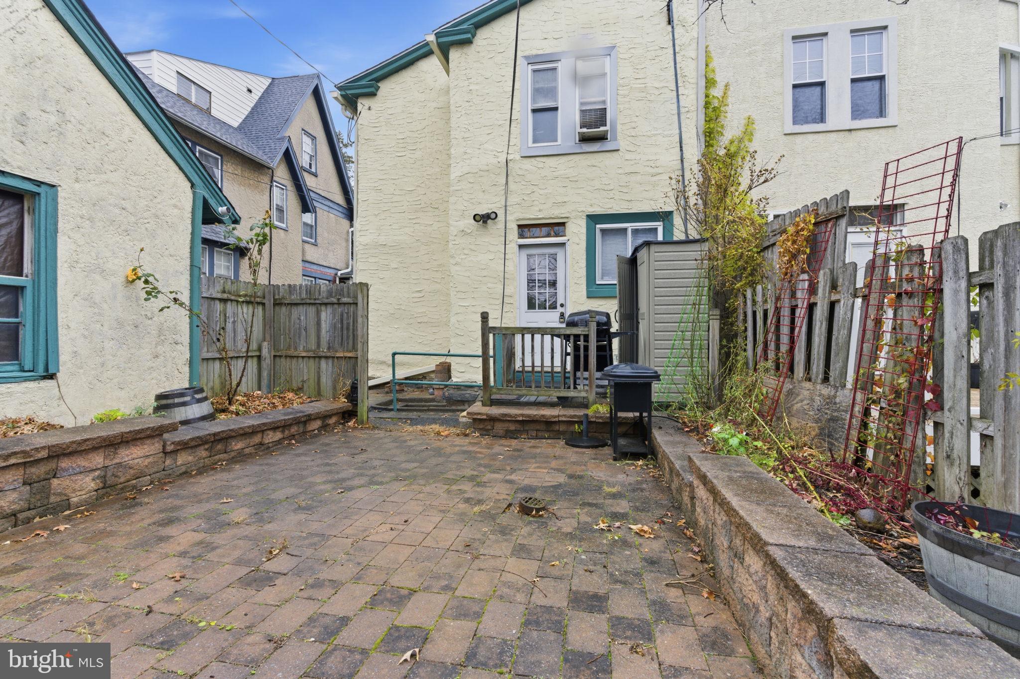 212 Upland Road Merion Station, PA 19066 - Photo 30 of 32 a backyard of a house with barbeque oven and table