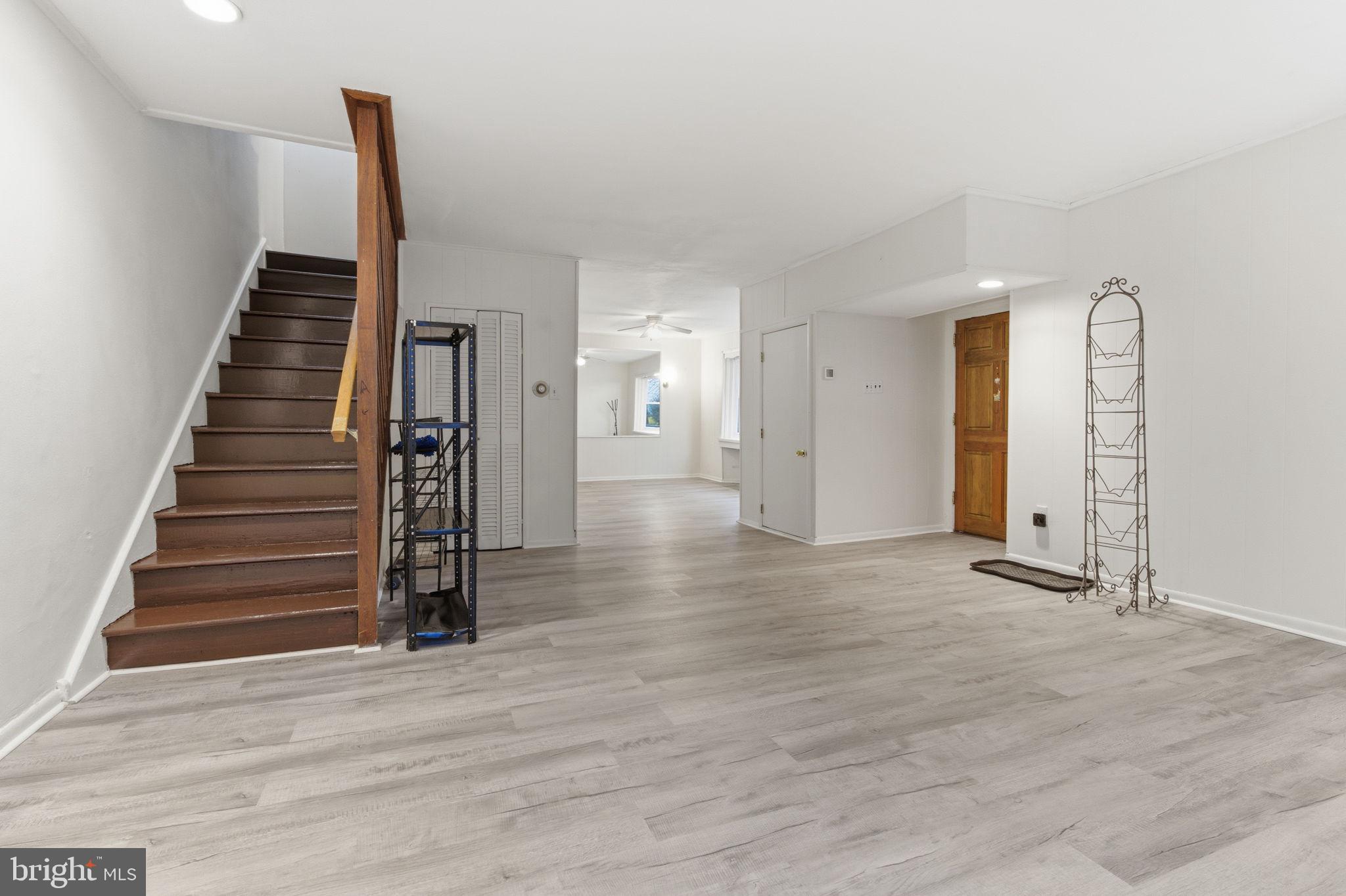 212 Upland Road Merion Station, PA 19066 - Photo 4 of 32 a view of a hallway with wooden floor and stairs