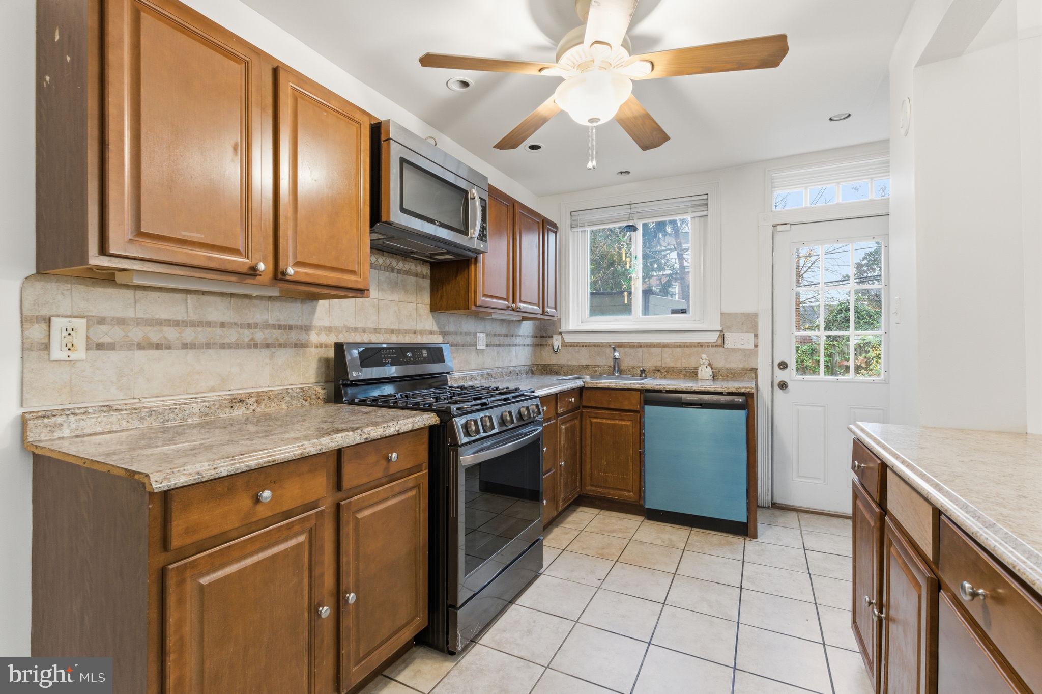 212 Upland Road Merion Station, PA 19066 - Photo 9 of 32 a kitchen with stainless steel appliances granite countertop a stove sink and cabinets