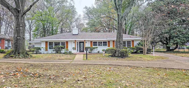 a front view of a house with garden and porch