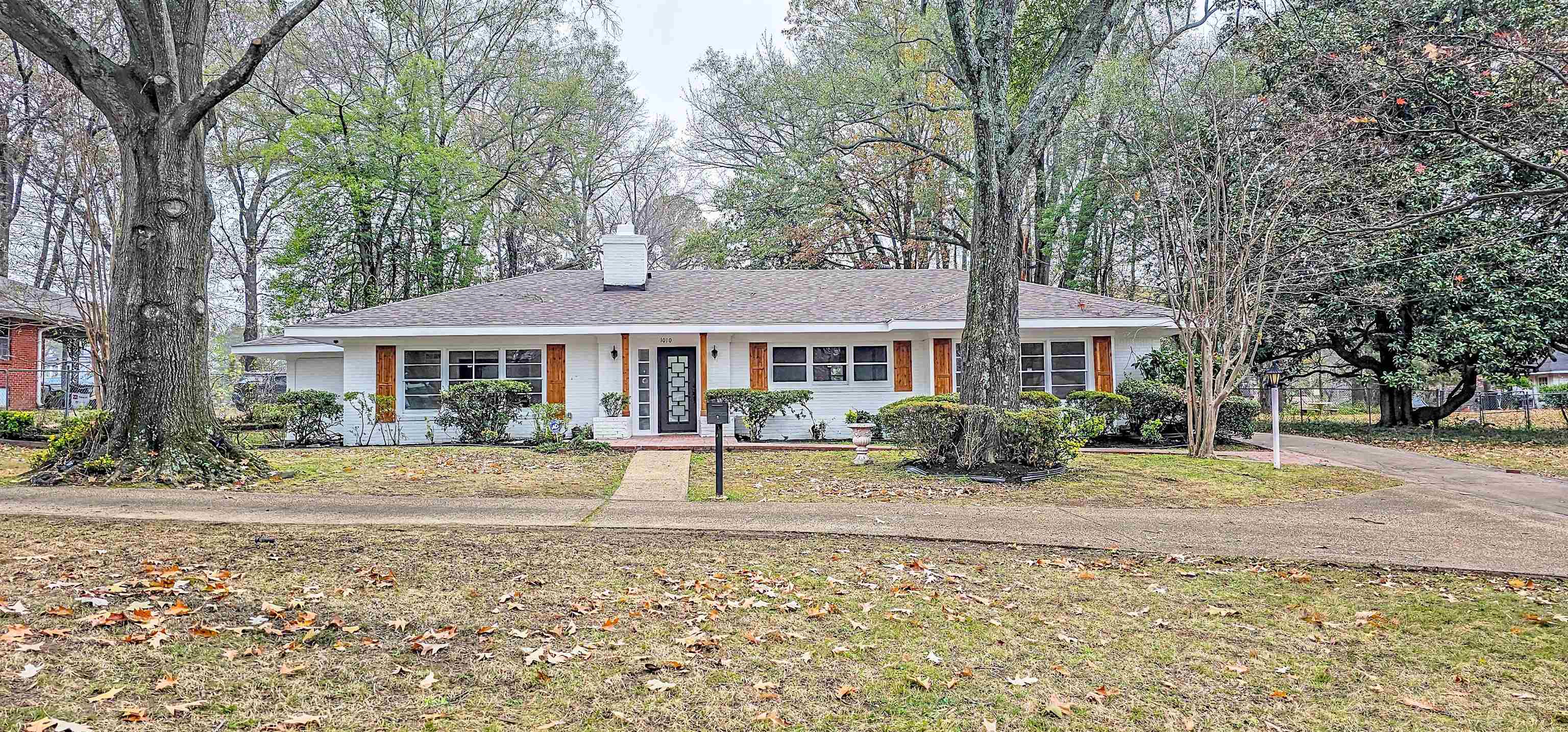a front view of a house with garden and porch