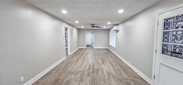 a view of hallway with wooden floor
