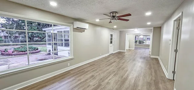 a view of a livingroom with wooden floor and a ceiling fan