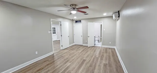 wooden floor in an empty room with a window