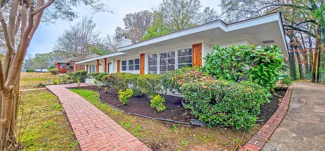 a front view of a house with garden
