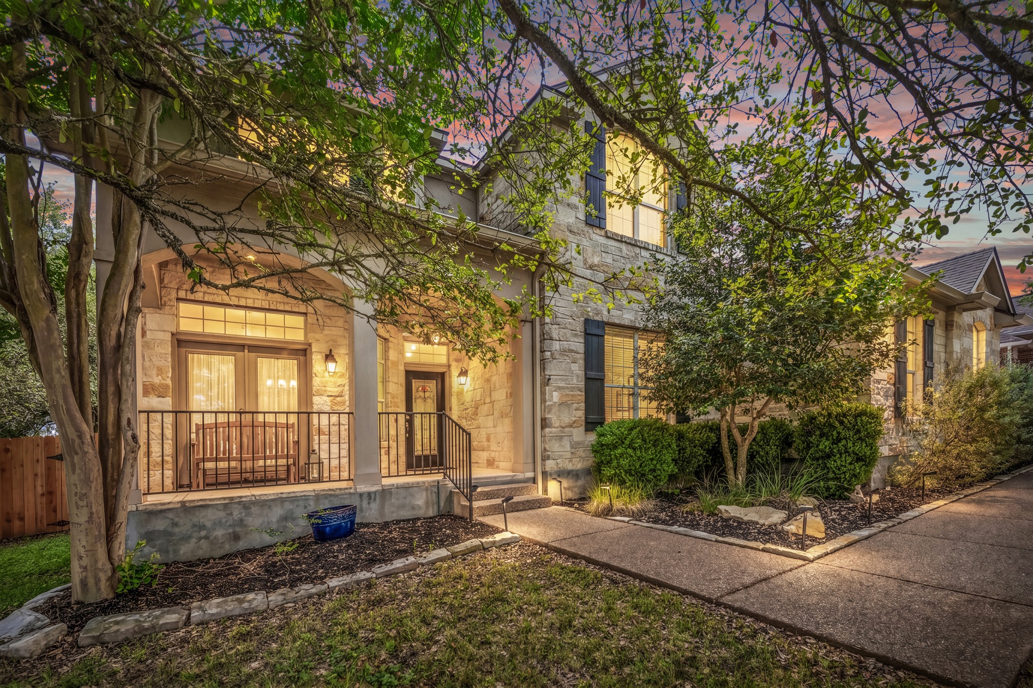 1023 Grassy Field Road Austin, TX 78737 - Photo 2 of 40 Stone facade residence with a covered front porch featuring a metal railing