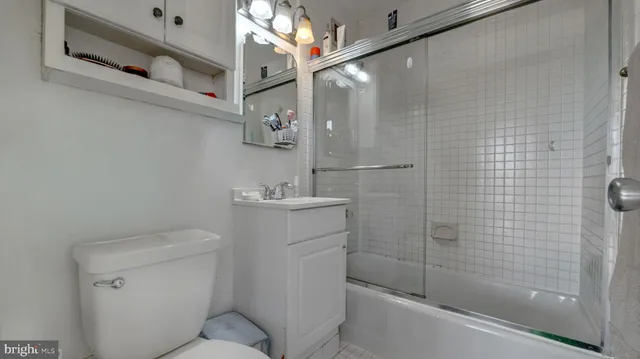 a bathroom with a toilet sink and shower