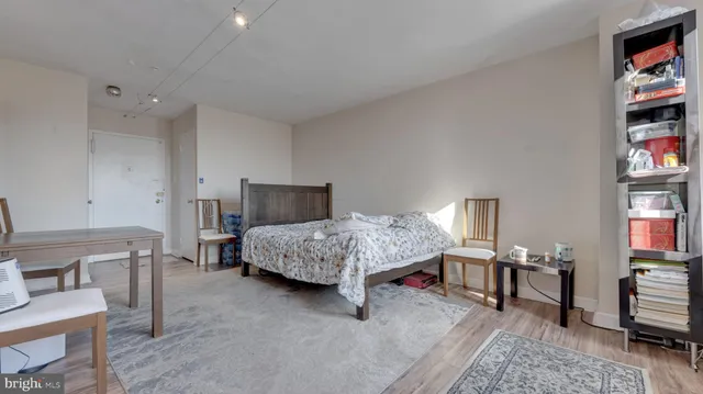 a bedroom with a bed a dresser and book shelf