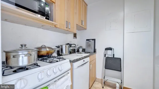 a kitchen with a stove and cabinets