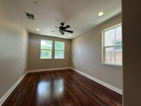 1749 Ettle Street Manteca, CA 95337 - Photo 12 of 12 an empty room with wooden floor and windows