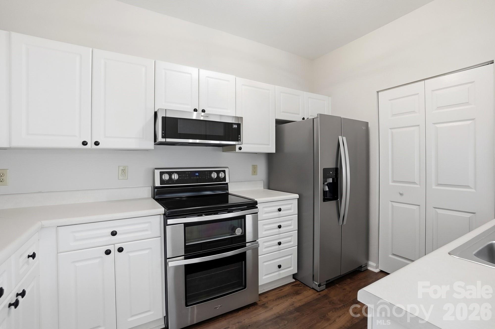 711 Stone Village Drive Fort Mill, SC 29708 - Photo 17 of 46 a kitchen with stainless steel appliances white cabinets and a refrigerator