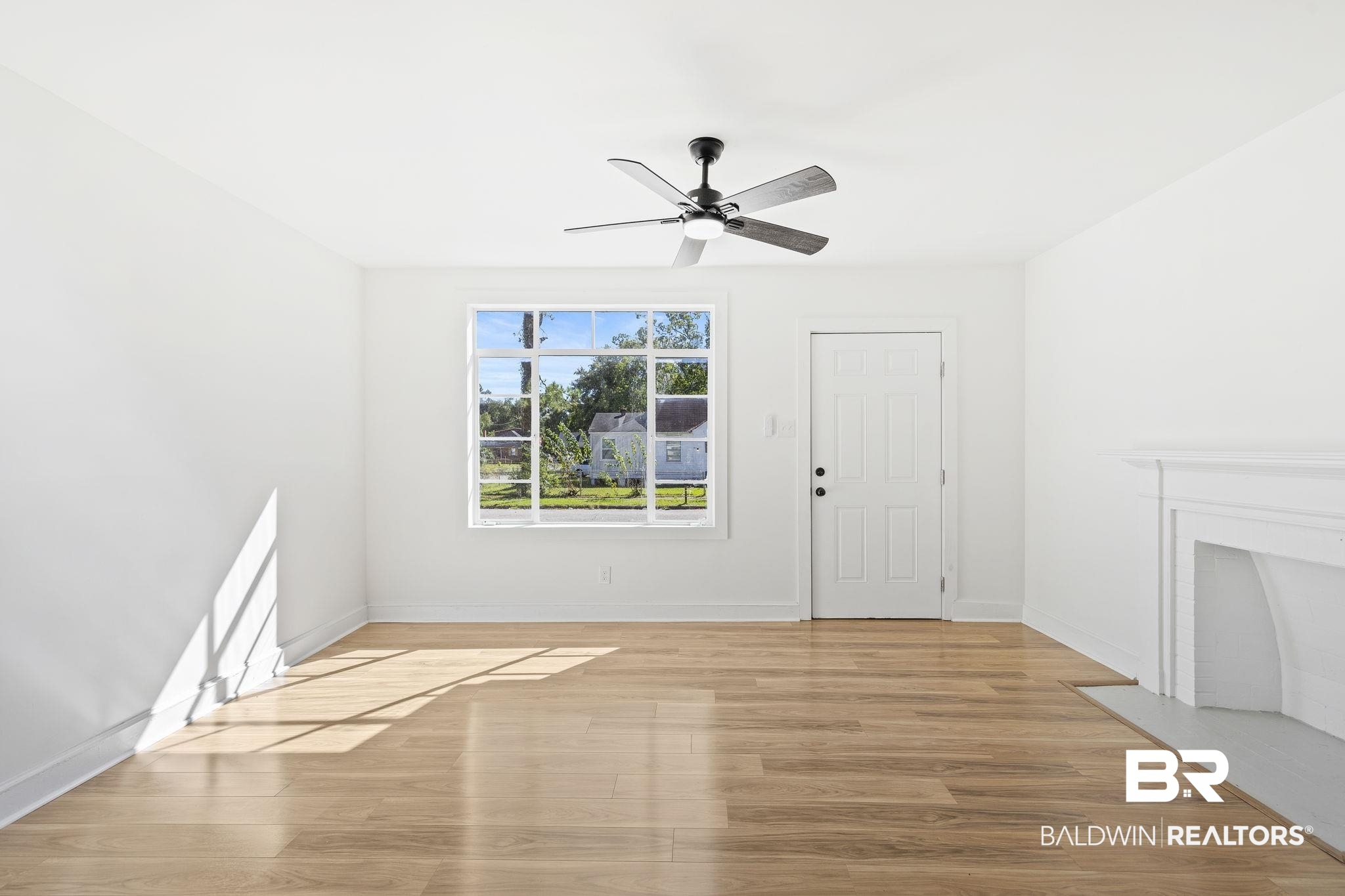1400 North Cloverleaf Circle Mobile, AL 36605 - Photo 8 of 17 Unfurnished living room featuring light wood-type flooring and ceiling fan