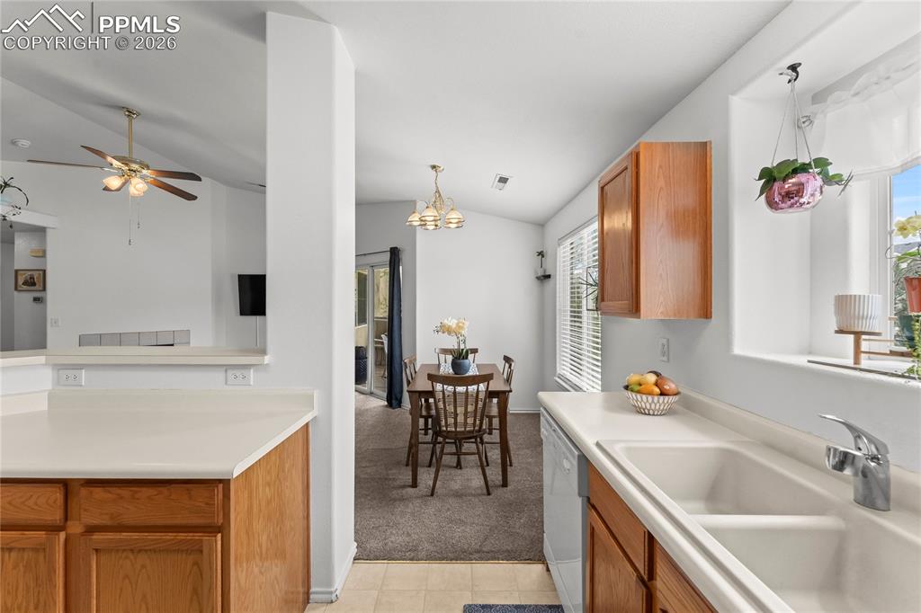 3976 Riviera Grove, Unit 203 Colorado Springs, CO 80922 - Photo 12 of 45 a kitchen with a sink appliances and cabinets