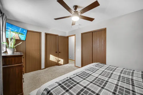 a bedroom with a bed and a large mirror