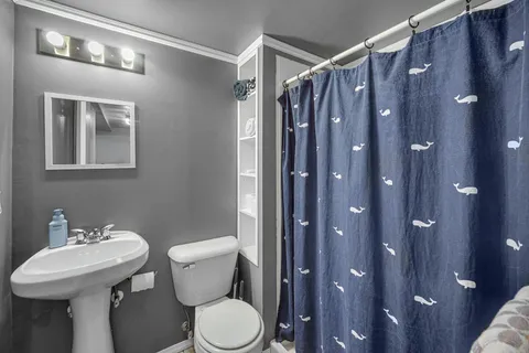 a bathroom with a sink toilet and shower