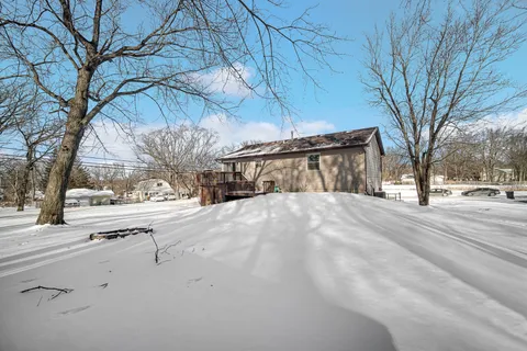 a view of road with a white house