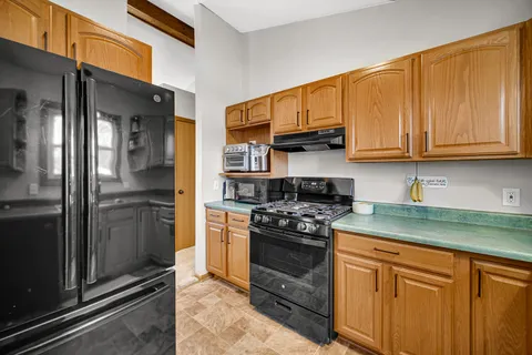 a kitchen with stainless steel appliances granite countertop a stove and a refrigerator