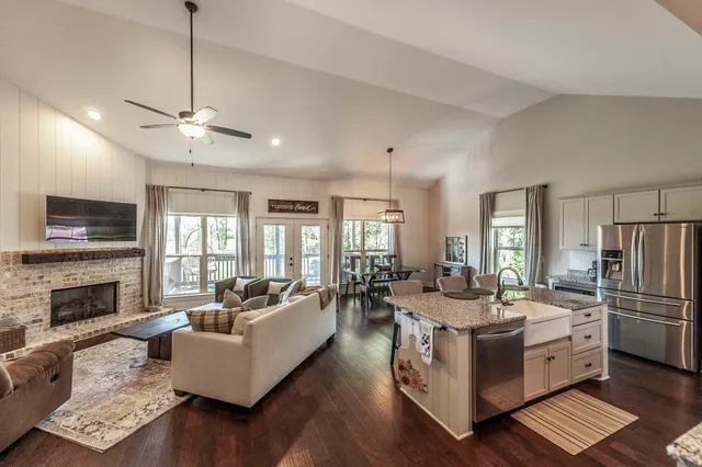 a living room with furniture fireplace and flat screen tv