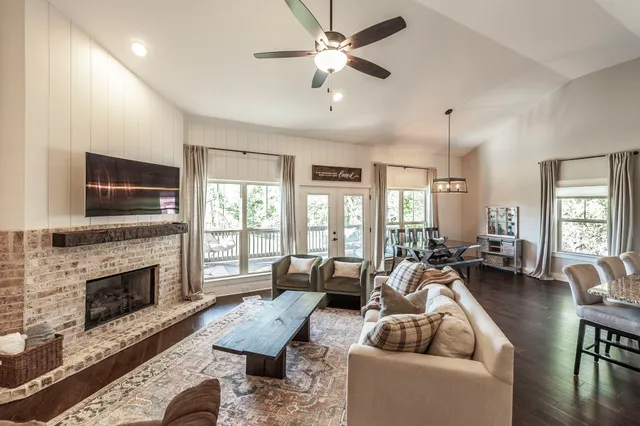 a living room with furniture a flat screen tv and a fireplace