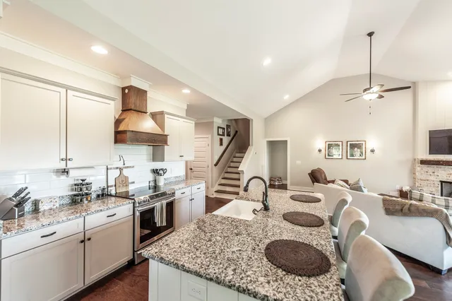 a living room with granite countertop kitchen island furniture and a wooden floor