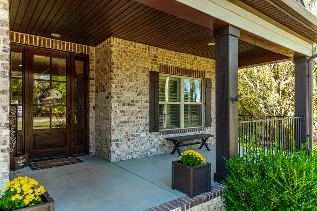 a front view of a house with outdoor seating and a garden