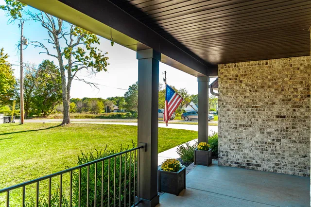 a view of a porch with furniture and garden