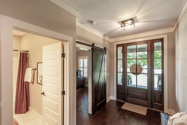 a view of entryway with wooden floor and livingroom view