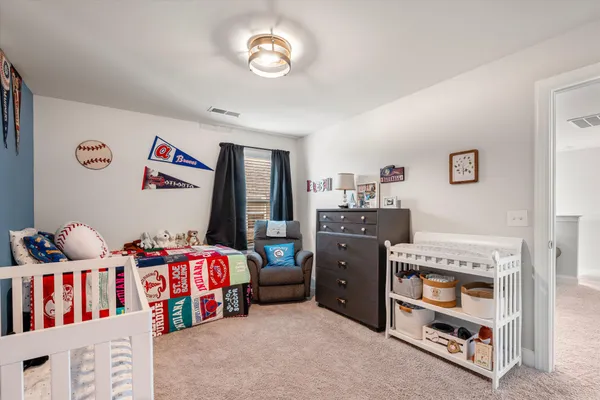 a bedroom with furniture and a book shelf