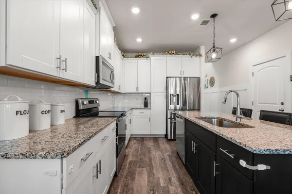 a kitchen with a sink stove and refrigerator