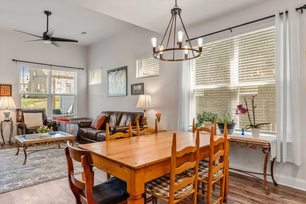 a living room with furniture a window and a chandelier
