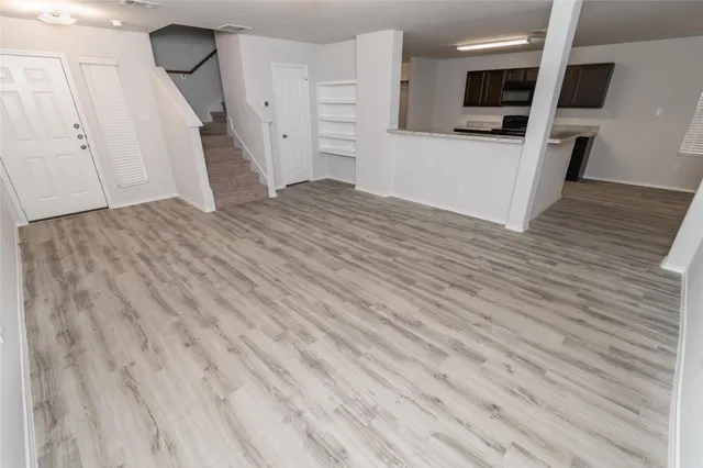 a view of a kitchen with wooden floor and a sink
