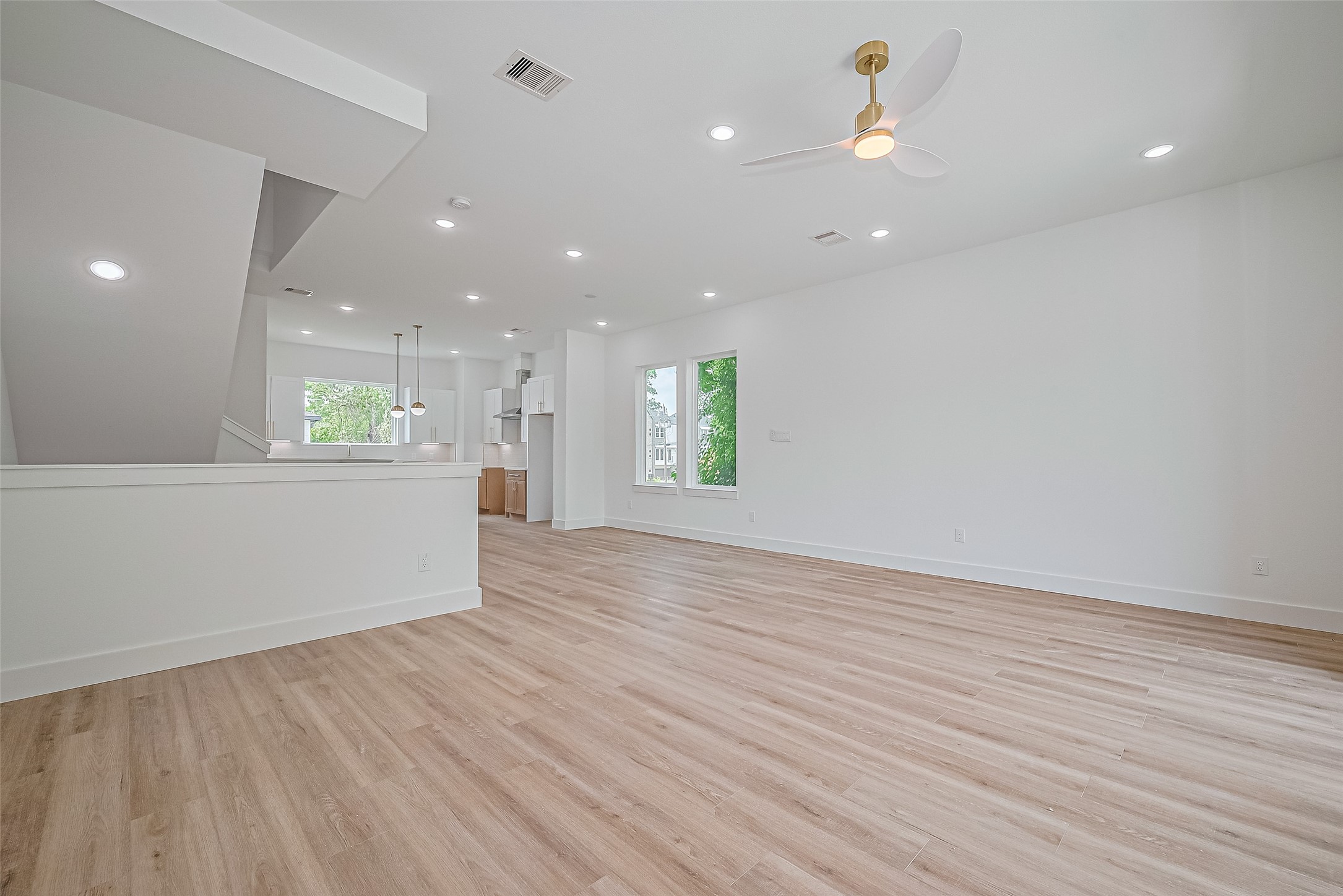 6023 Maybell Street Houston, TX 77091 - Photo 11 of 37 an empty room with wooden floor and windows