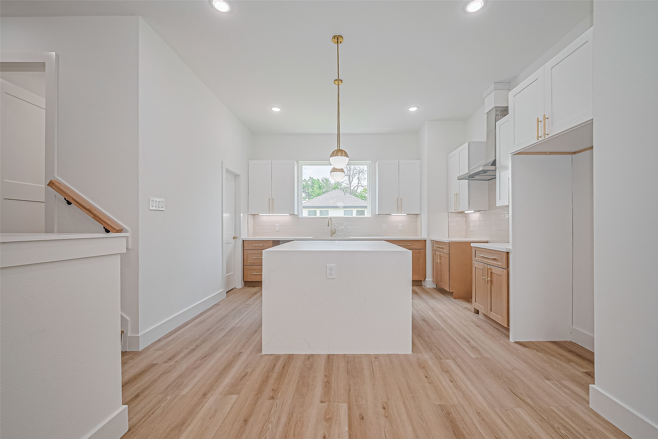 6023 Maybell Street Houston, TX 77091 - Photo 13 of 37 a kitchen with kitchen island wooden floor center island and stainless steel appliances