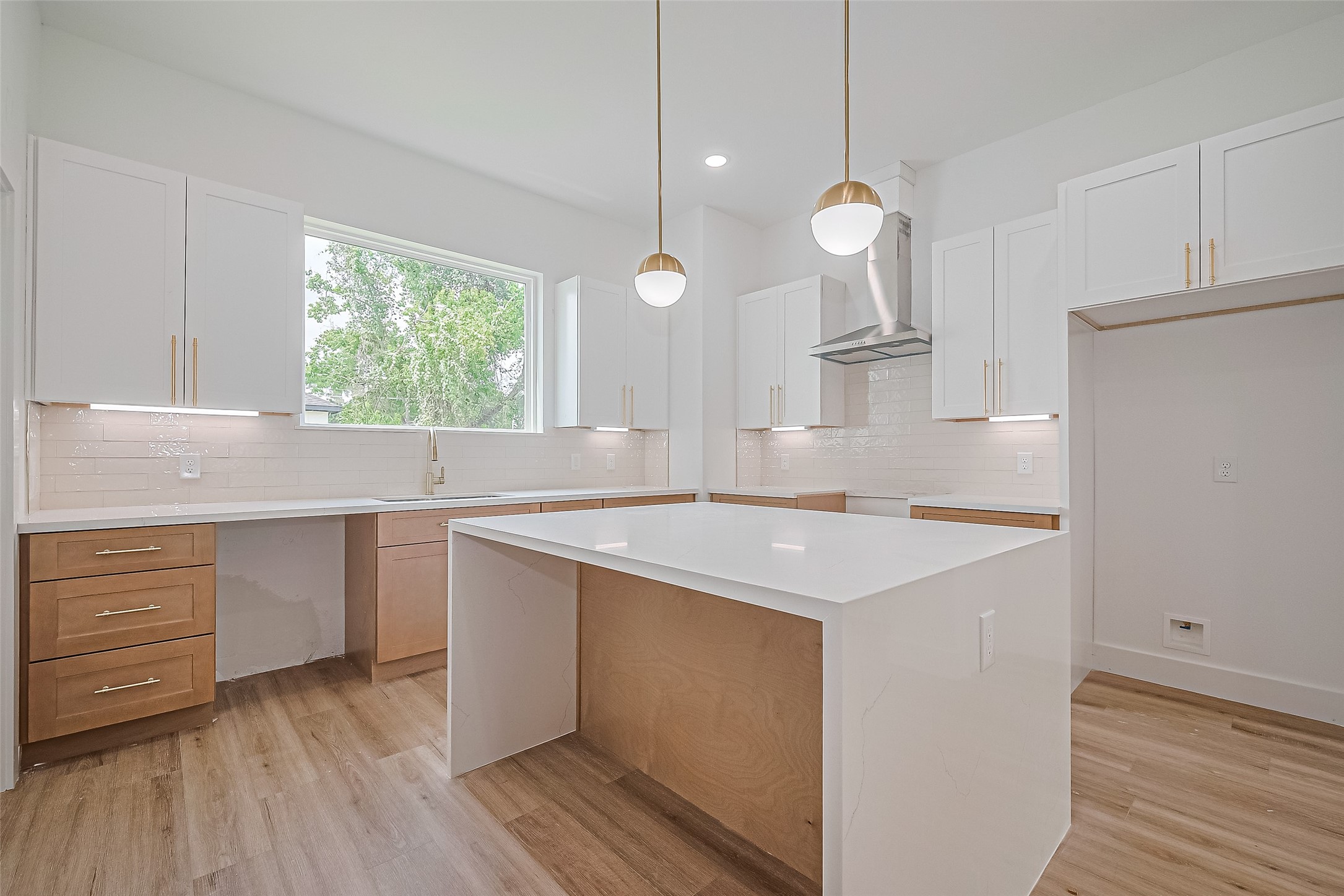 6023 Maybell Street Houston, TX 77091 - Photo 15 of 37 a kitchen with a stove a sink and a window with wooden floors