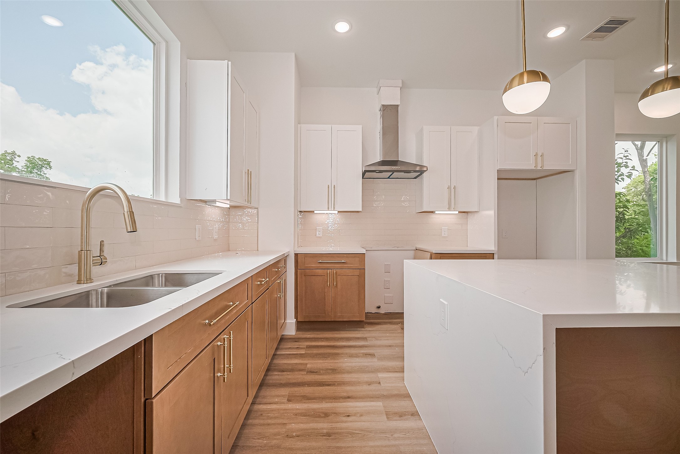 6023 Maybell Street Houston, TX 77091 - Photo 17 of 37 a kitchen with white cabinets and sink