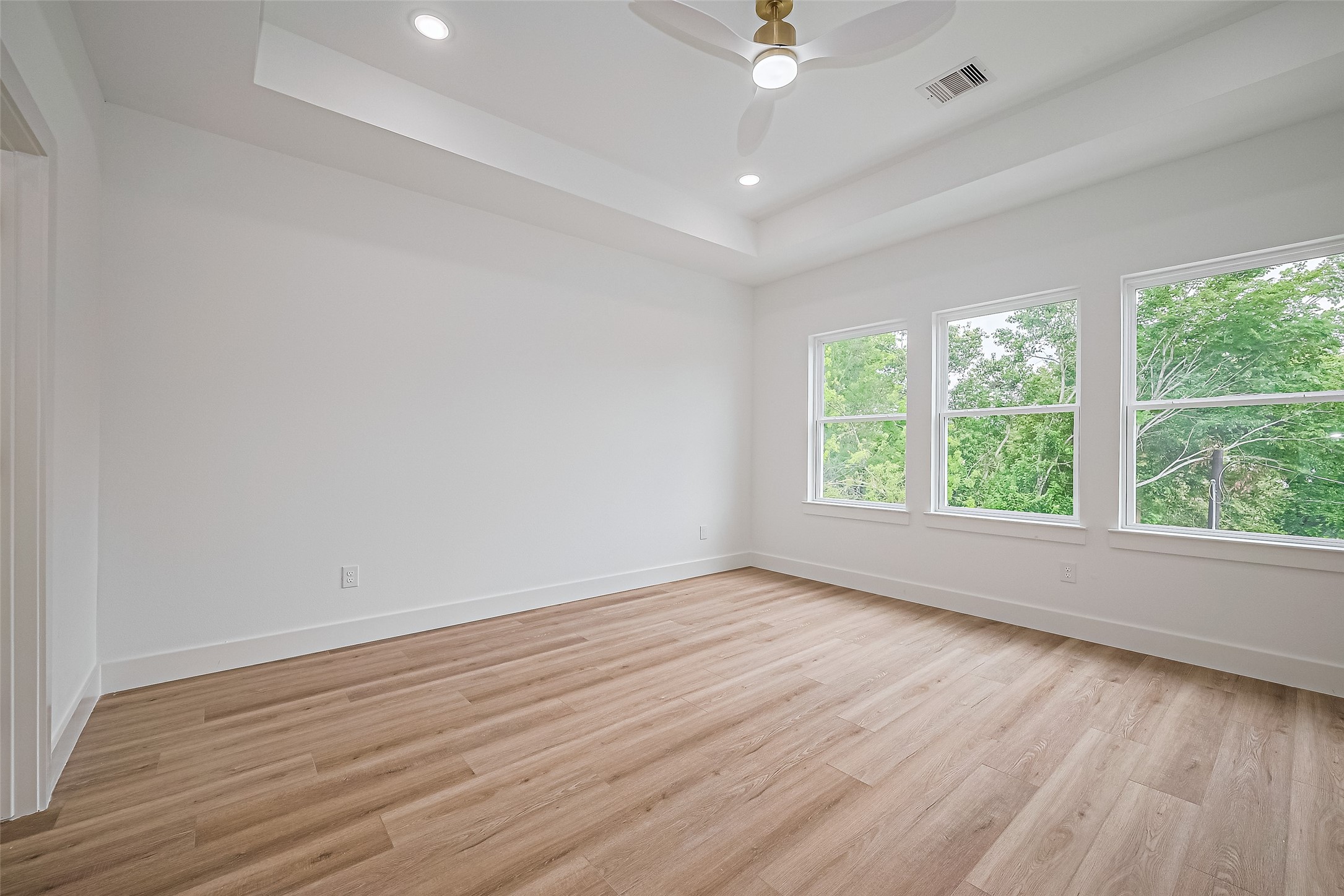 6023 Maybell Street Houston, TX 77091 - Photo 22 of 37 an empty room with wooden floor and windows