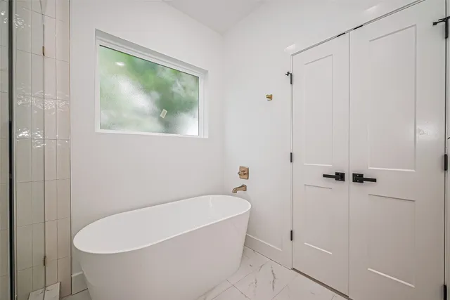 a bathroom with a bathtub and a shower