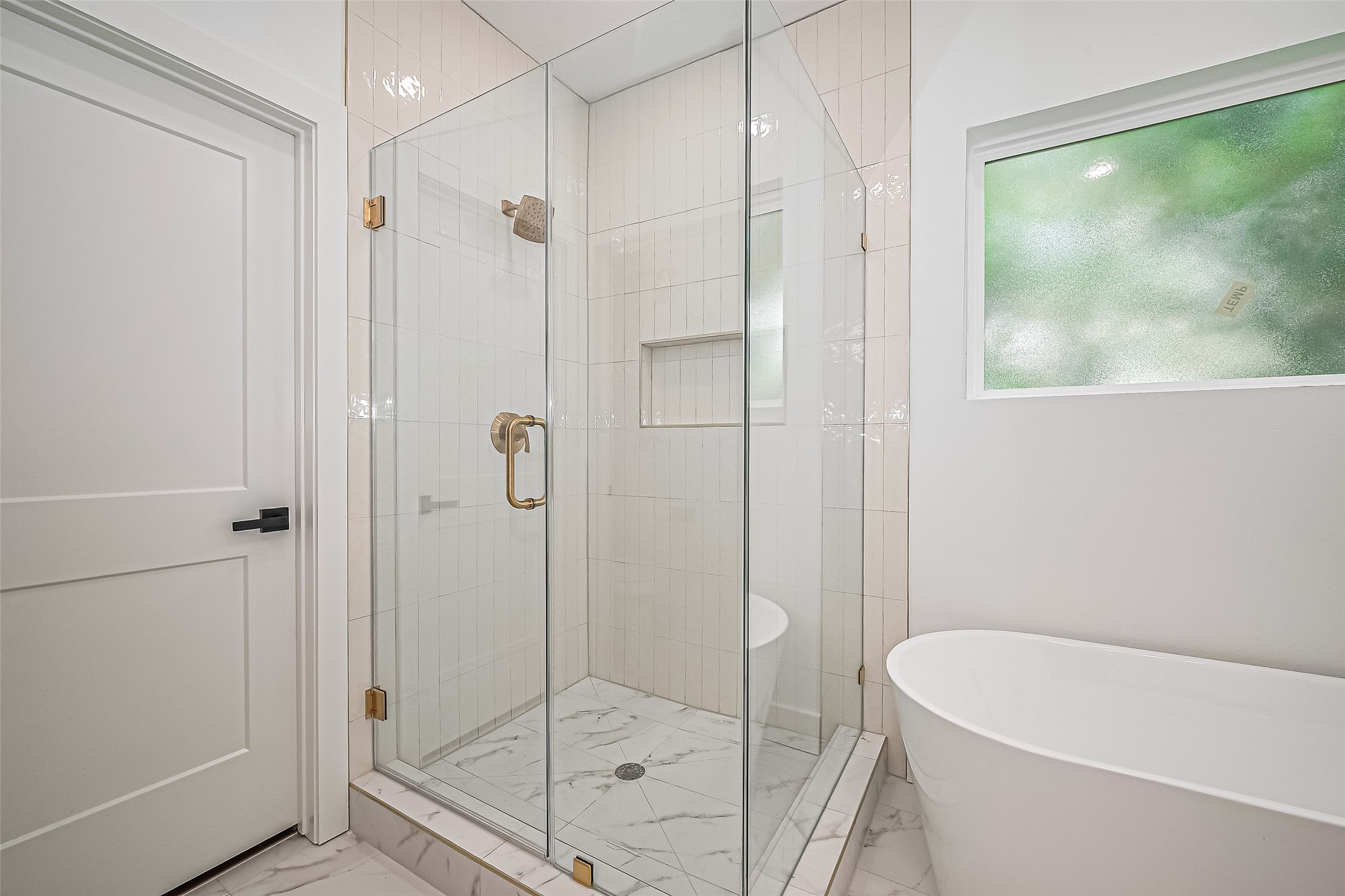 6023 Maybell Street Houston, TX 77091 - Photo 28 of 37 a bathroom with a bathtub and a shower