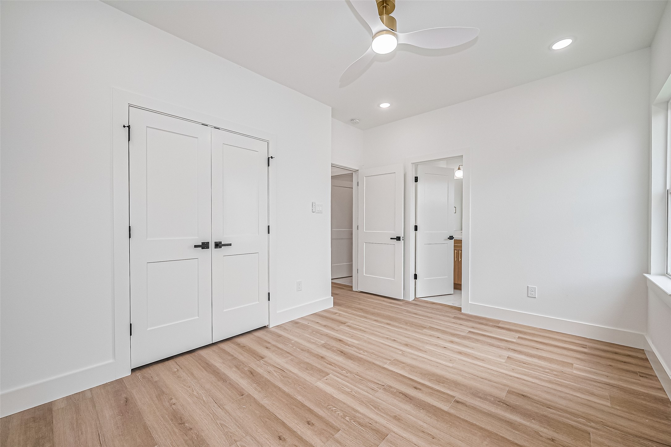 6023 Maybell Street Houston, TX 77091 - Photo 32 of 37 an empty room with wooden floor and a ceiling fan
