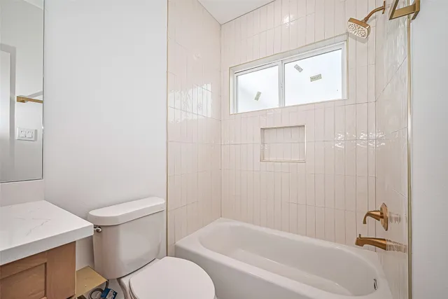 a bathroom with a sink toilet and mirror