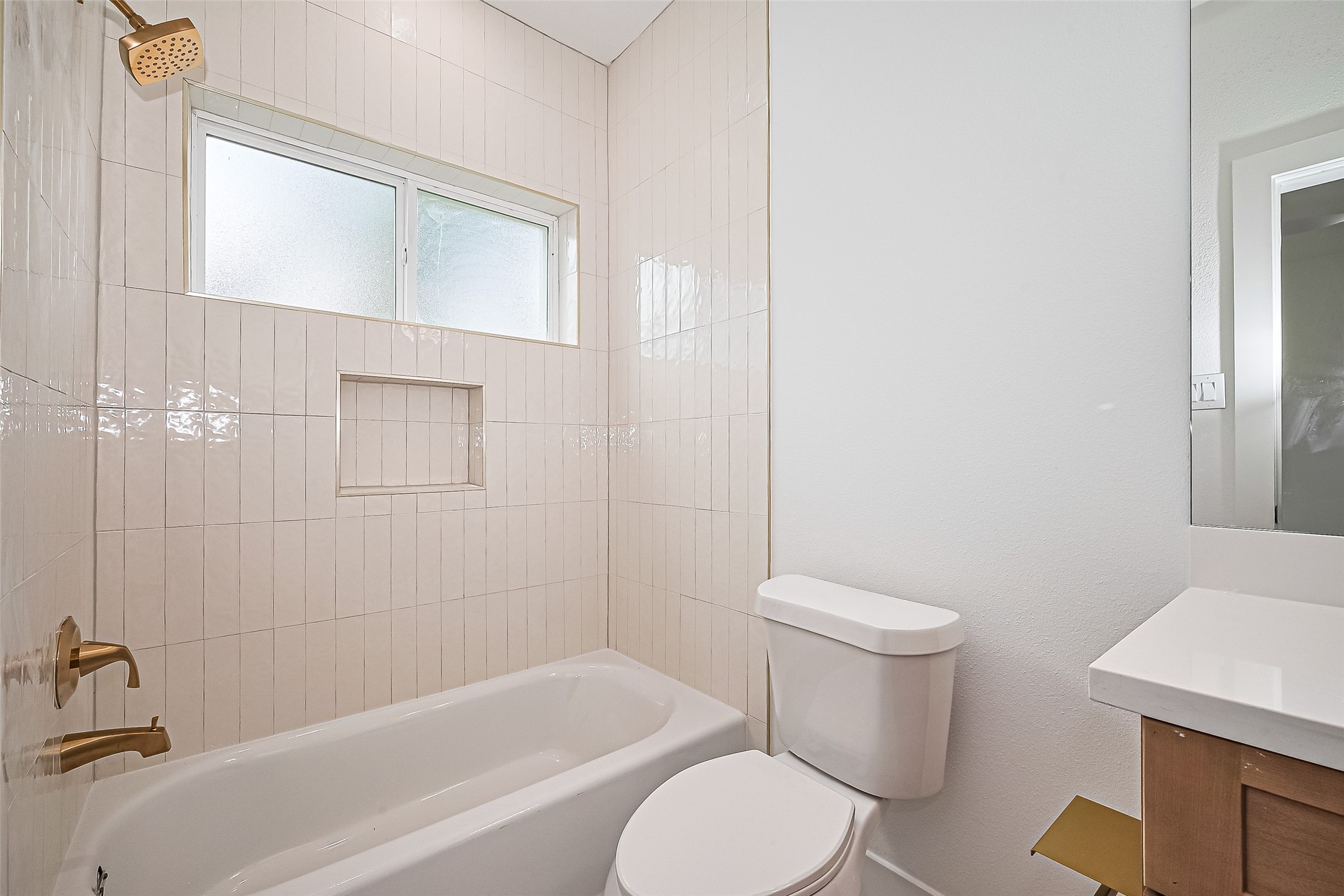 6023 Maybell Street Houston, TX 77091 - Photo 5 of 37 a white toilet sitting next to a bath tub