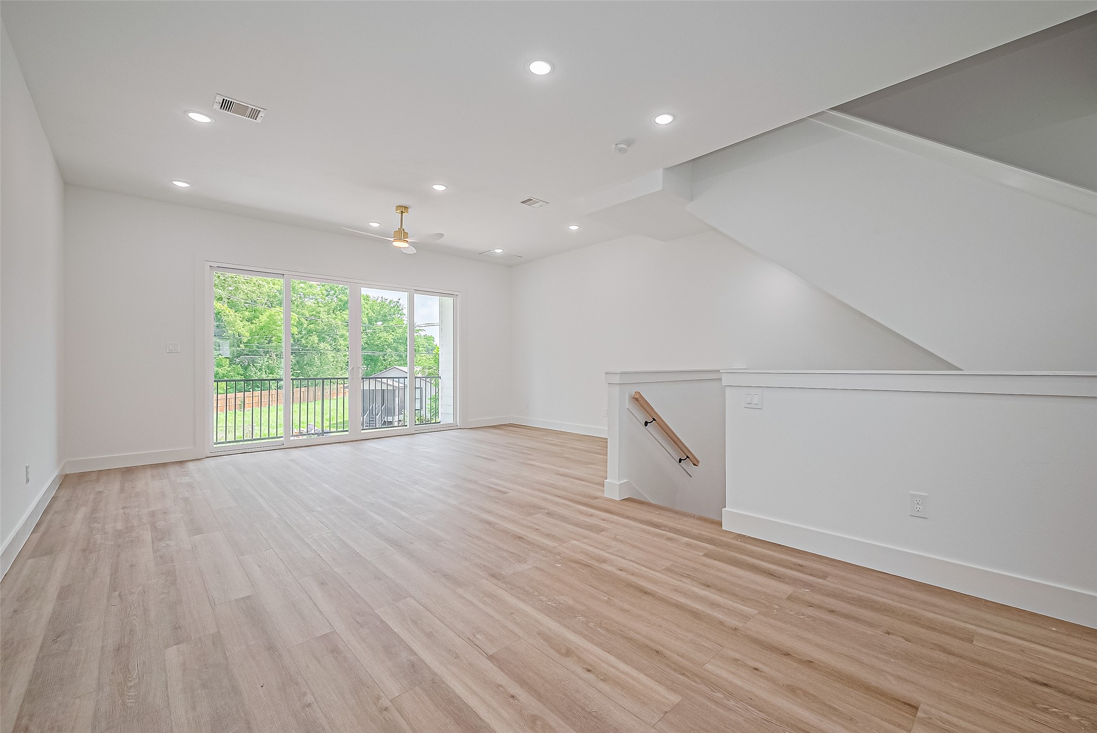 6023 Maybell Street Houston, TX 77091 - Photo 7 of 37 an empty room with wooden floor and windows