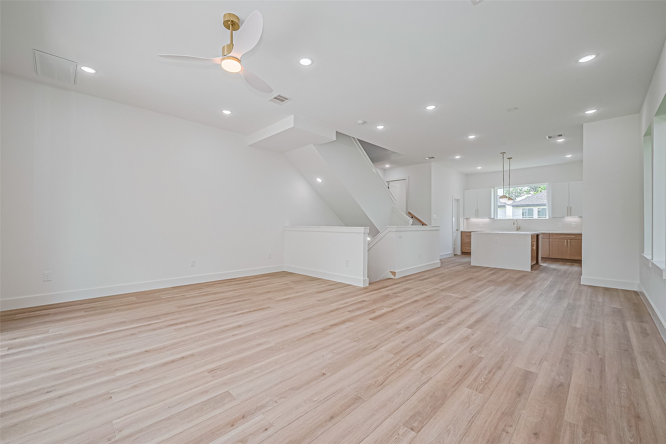 6023 Maybell Street Houston, TX 77091 - Photo 10 of 37 a view of an empty room with wooden floor kitchen appliances and a window