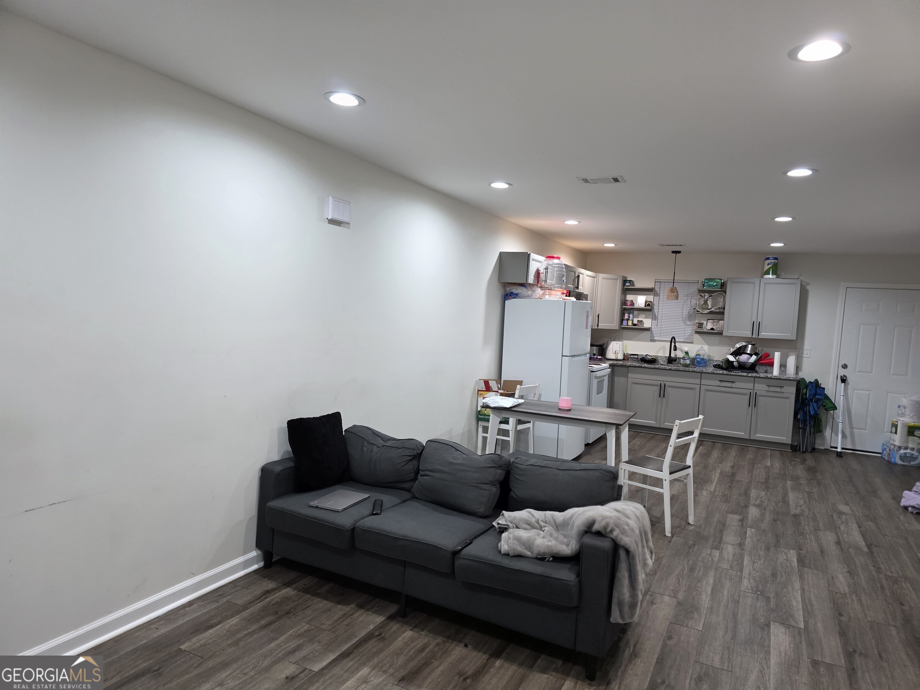 317 Preston Street Fort Valley, GA 31030 - Photo 2 of 7 a living room with furniture and kitchen view
